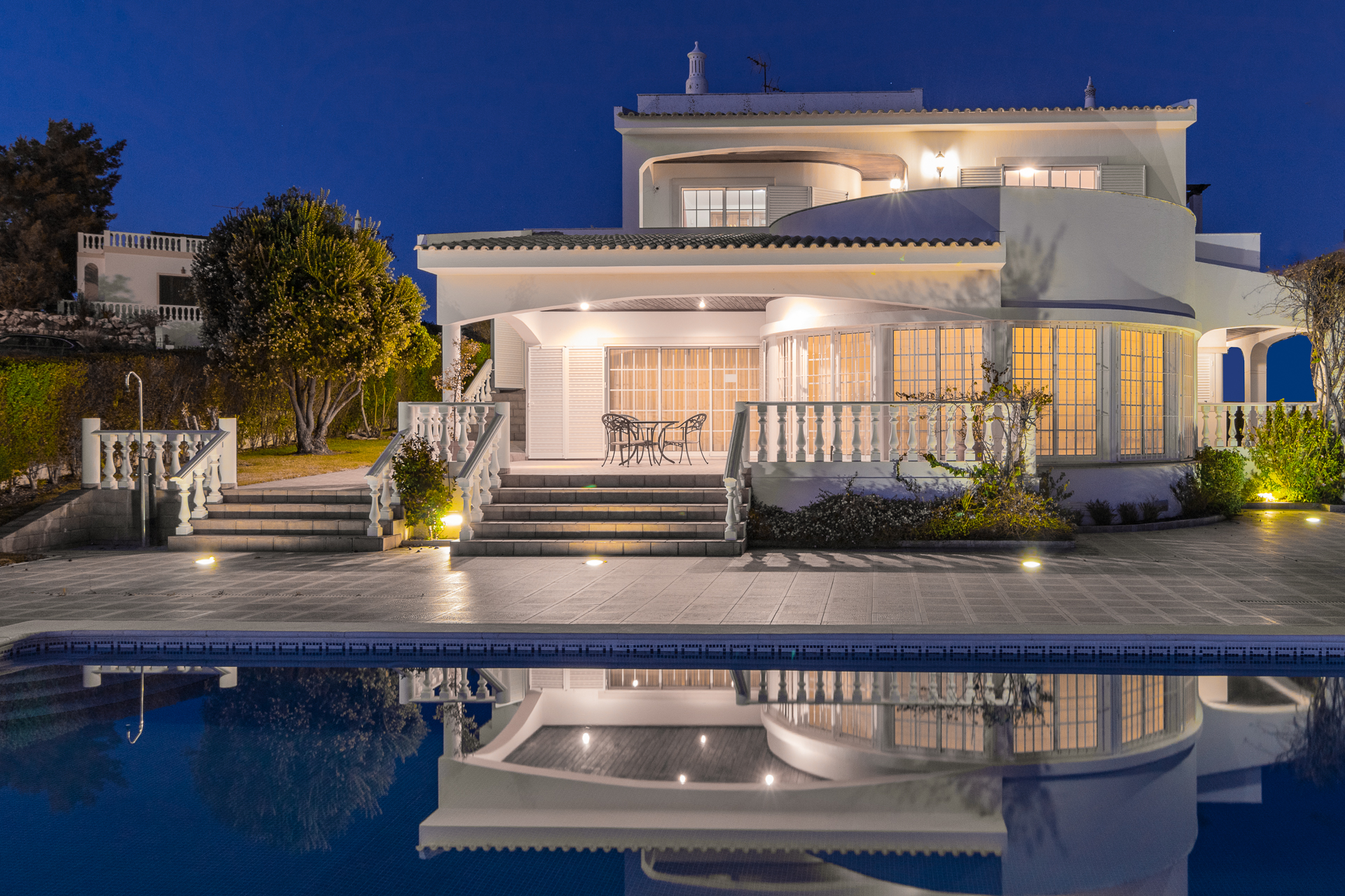 Holiday rental villa exterior with pool photographed at golden hour