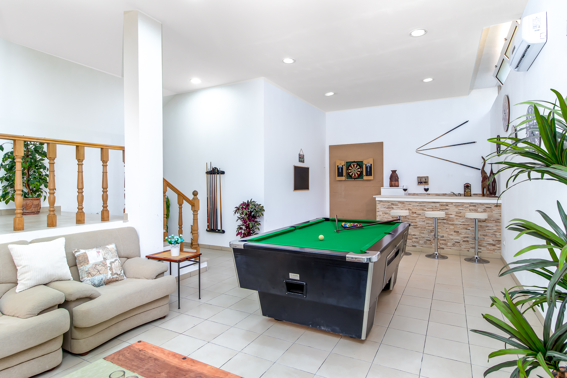 Beautifully lit games room interior showing the multi-layer lighting technique